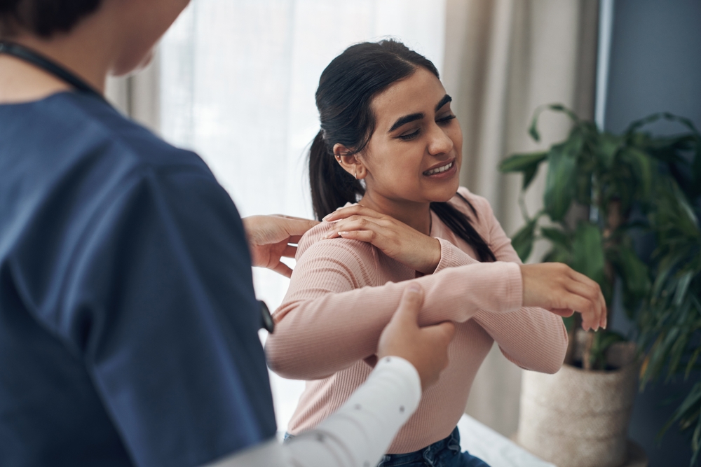 A woman works with a physical therapist to improve proprioception